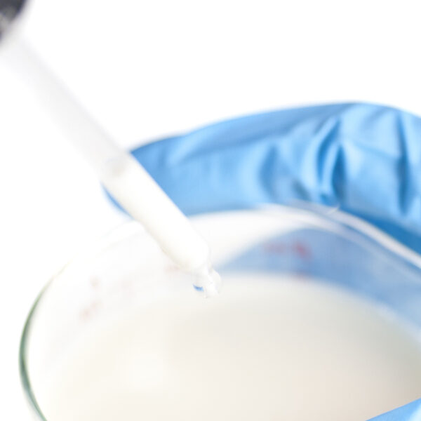 close-up of a can of milkclose-up of human hand with gloves testing milk